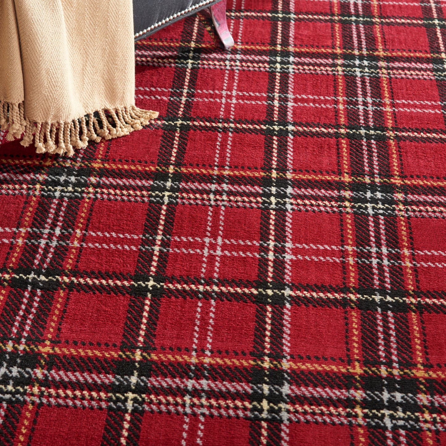 Red tartan wool rug with beige fringe edge, plaid pattern.