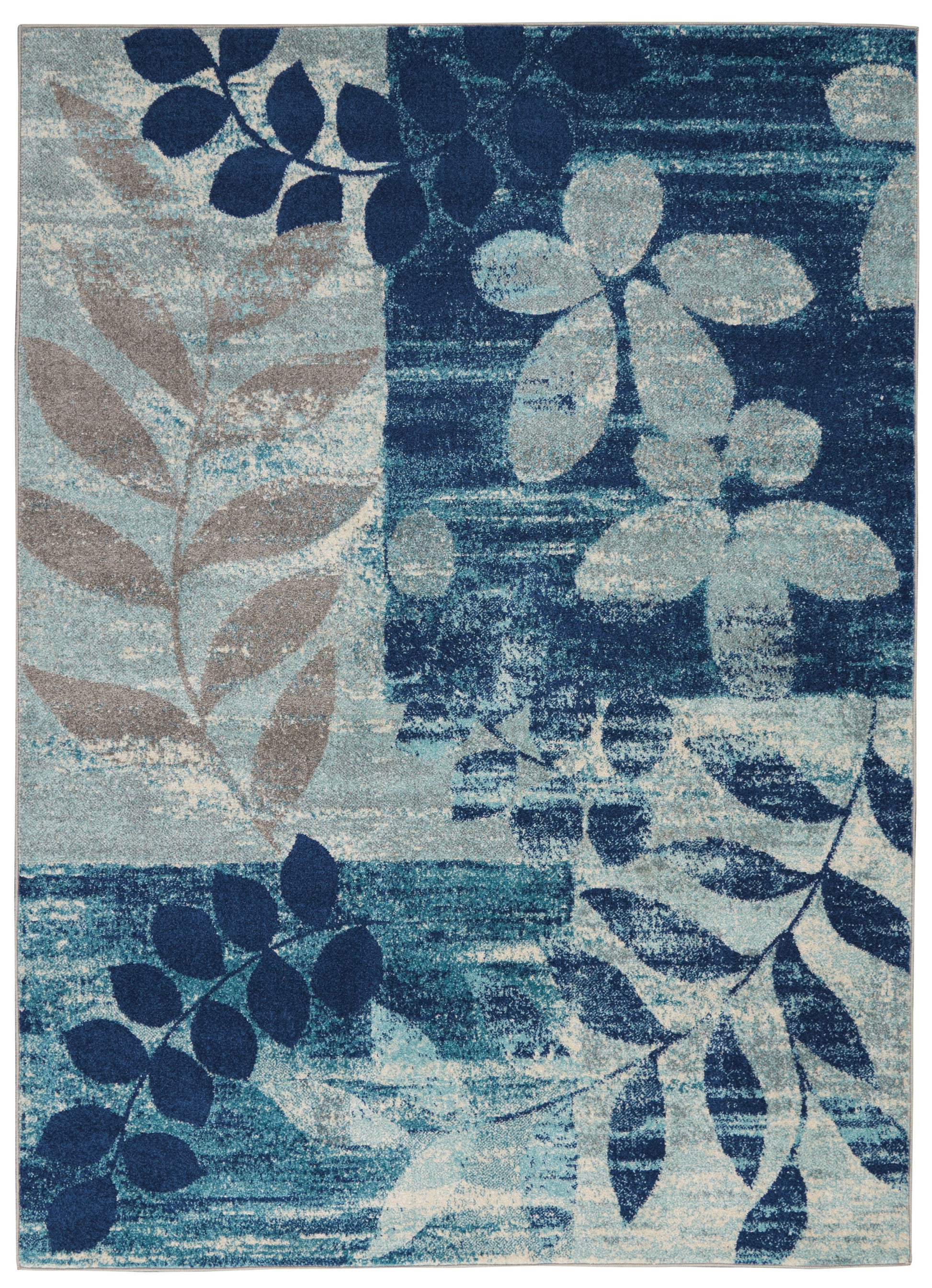 Rectangular area rug with abstract blue botanical leaves in navy, teal & beige; modern, soft-textured decor accent.