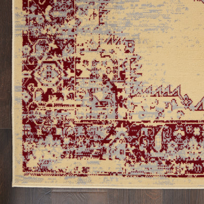 Oriental-pattern area rug with burgundy, cream, and pale blue hues on dark wood floor.