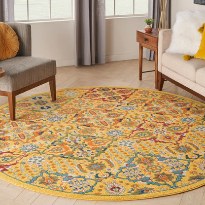 Round oriental-style floral rug with yellow background and blue, red, teal accents in a bright living room.