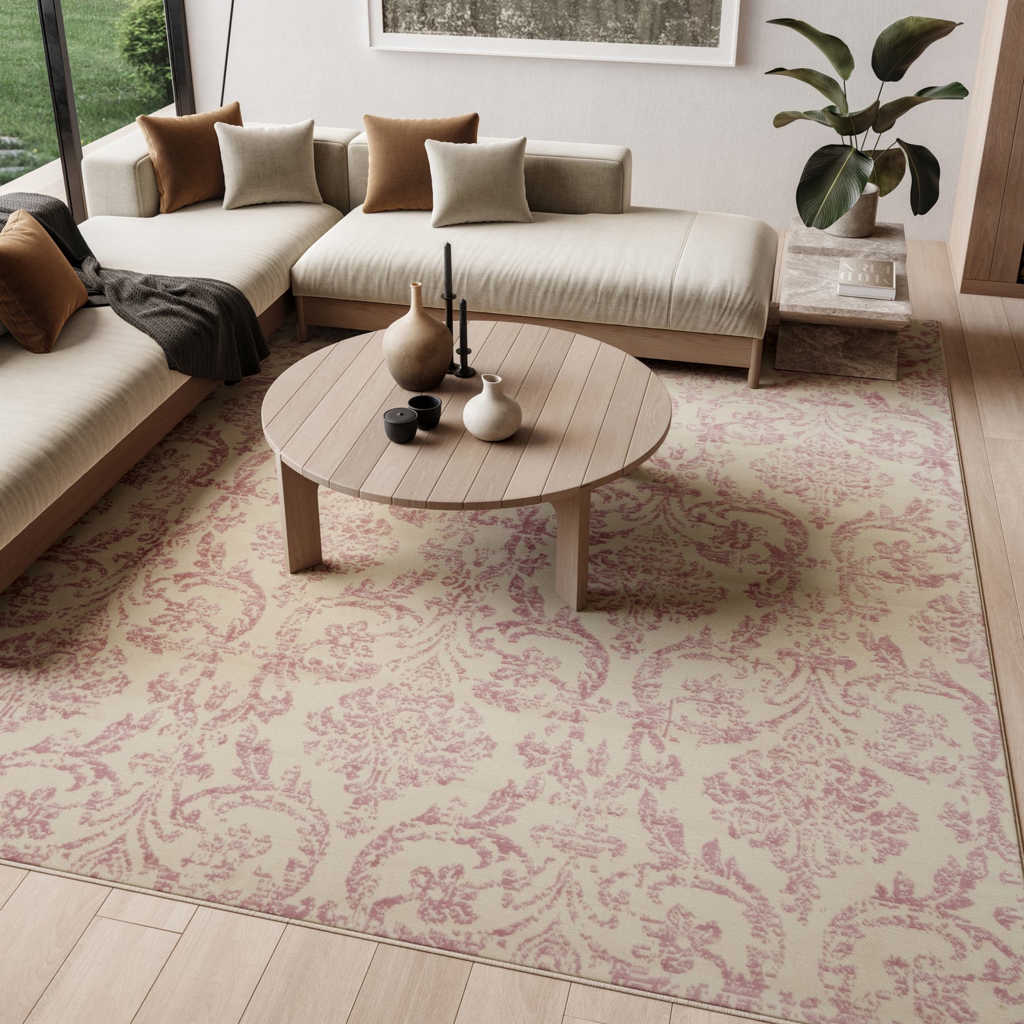 Round light wood coffee table on a floral rug beside cream sectional sofas with beige and brown cushions.