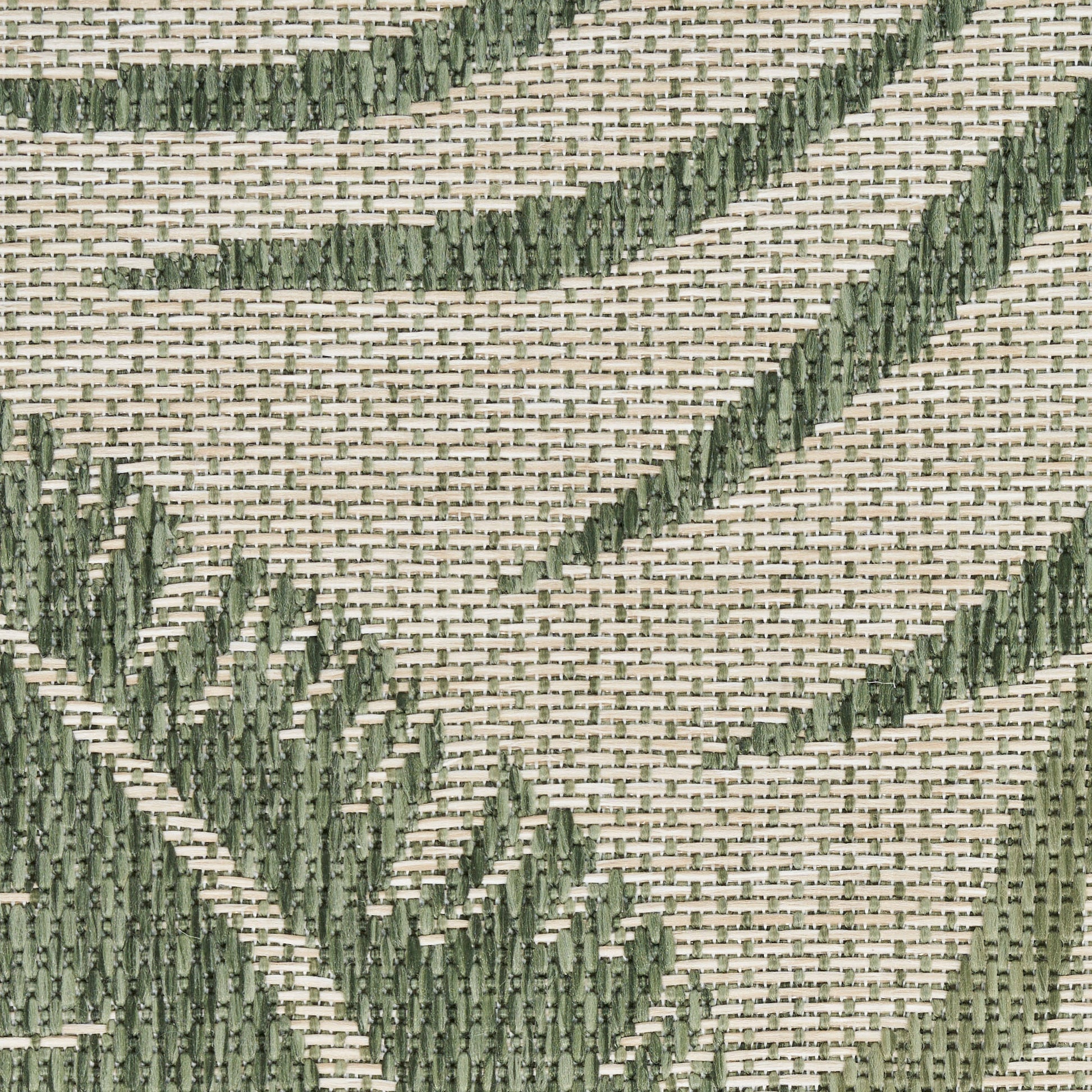 Beige woven outdoor rug with dark green embroidered leaf patterns; textured close-up.