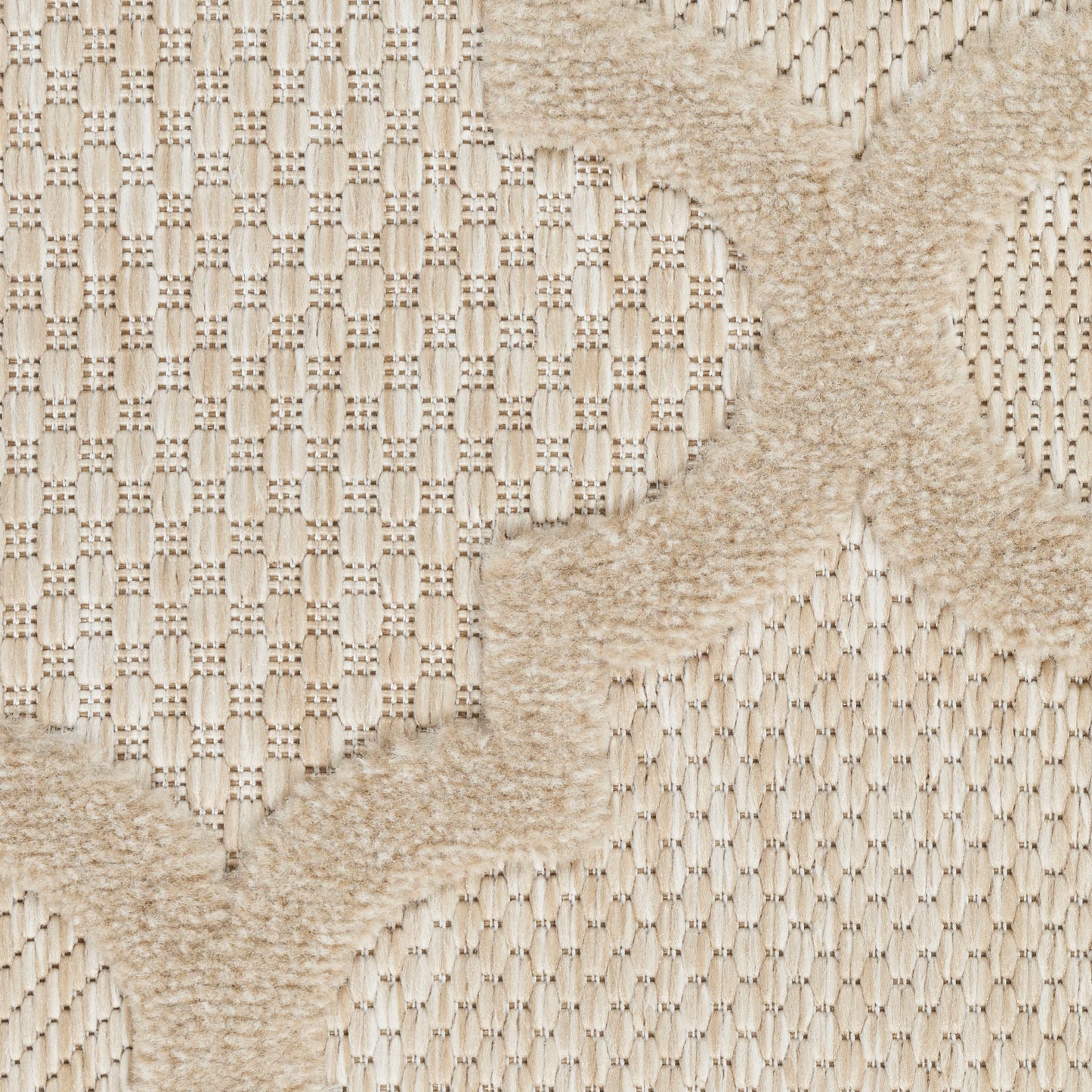 Beige woven rug with a soft shaggy X-shaped motif over a textured looped base.