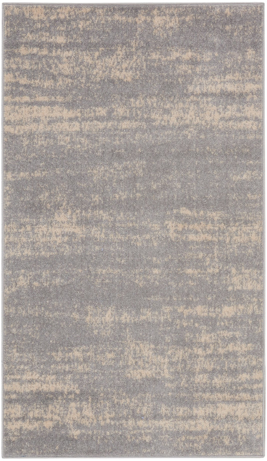 Rectangular area rug in gray with beige speckled abstract pattern; soft, plush texture and modern style.