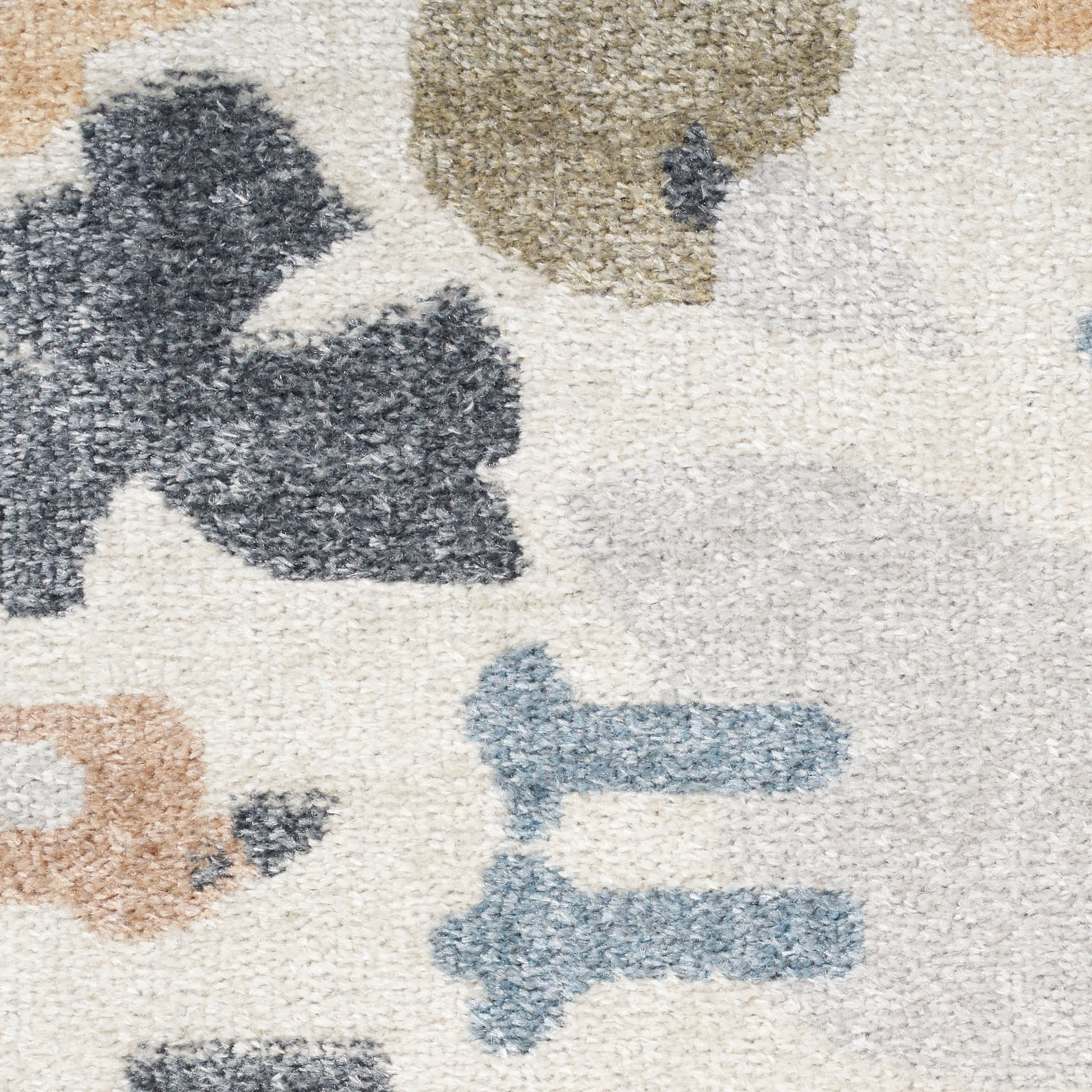 Ivory shag rug with abstract leaf shapes in navy & tan & olive & gray; plush pile, modern abstract style.