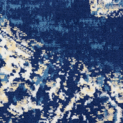 Close-up of a deep blue rug with abstract cream and pale blue speckles.