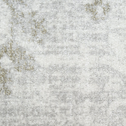 Light gray area rug with a subtle distressed beige-gold pattern and plush texture.