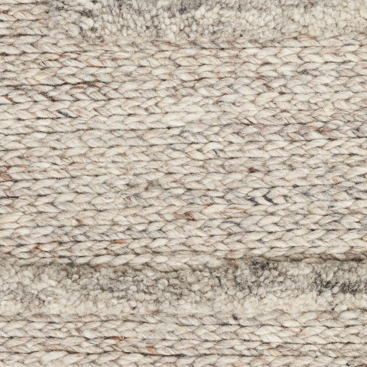 Beige chunky-knit wool rug close-up with looped fibers and a soft border for cozy living spaces.