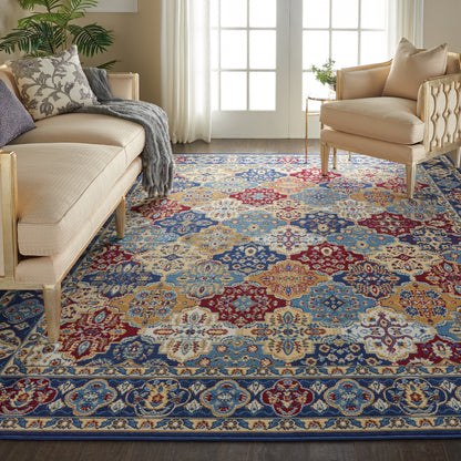 Living room with a vibrant multicolor oriental rug in blue, red, and beige, beige tufted sofas, plant, and French doors.