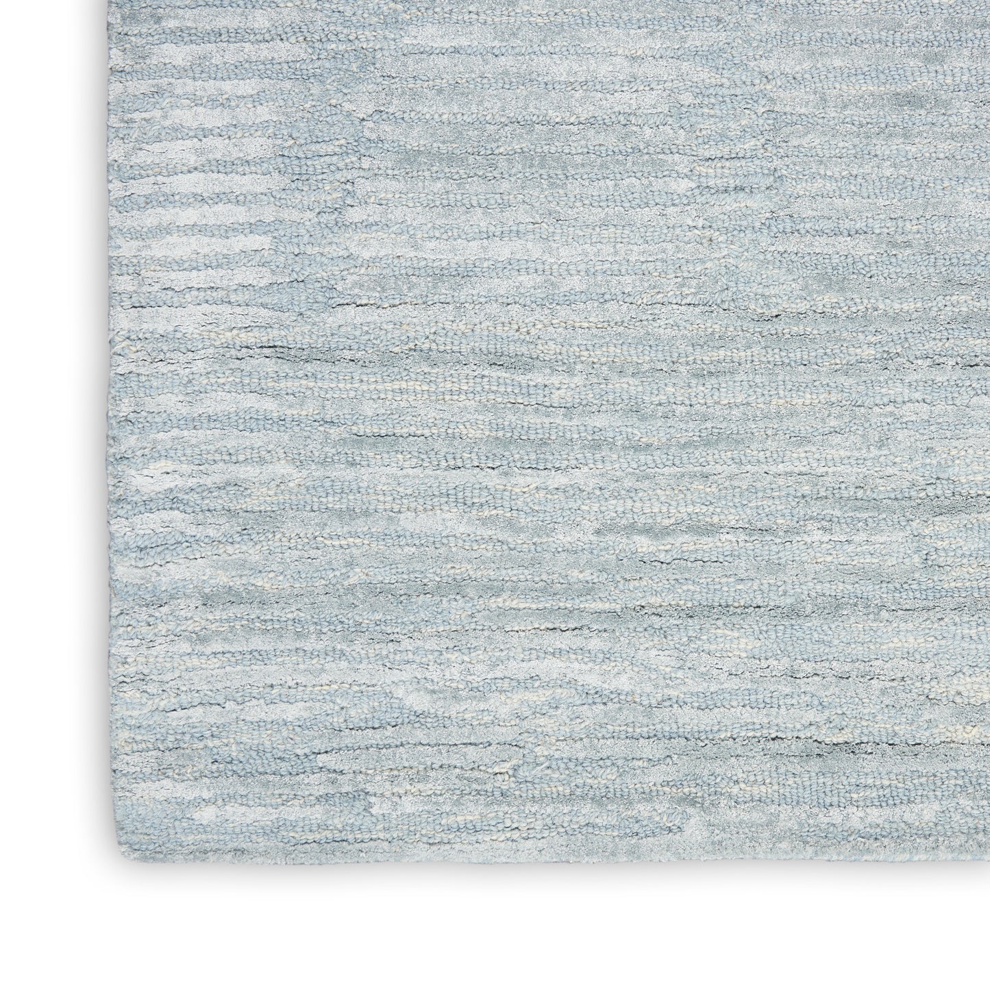 Light blue textured rug with plush, wavy pile and subtle shading; soft, cozy decor accent.