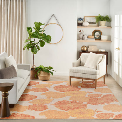 Cozy living room with cream sofa, striped armchair, peach floral rug, potted plants, and wood shelves with decor.
