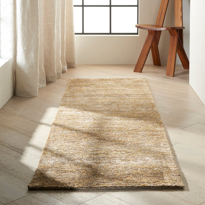 Beige woven runner rug on light wood floor in sunlit room, near a wooden chair; natural fiber style for hallway or entry.