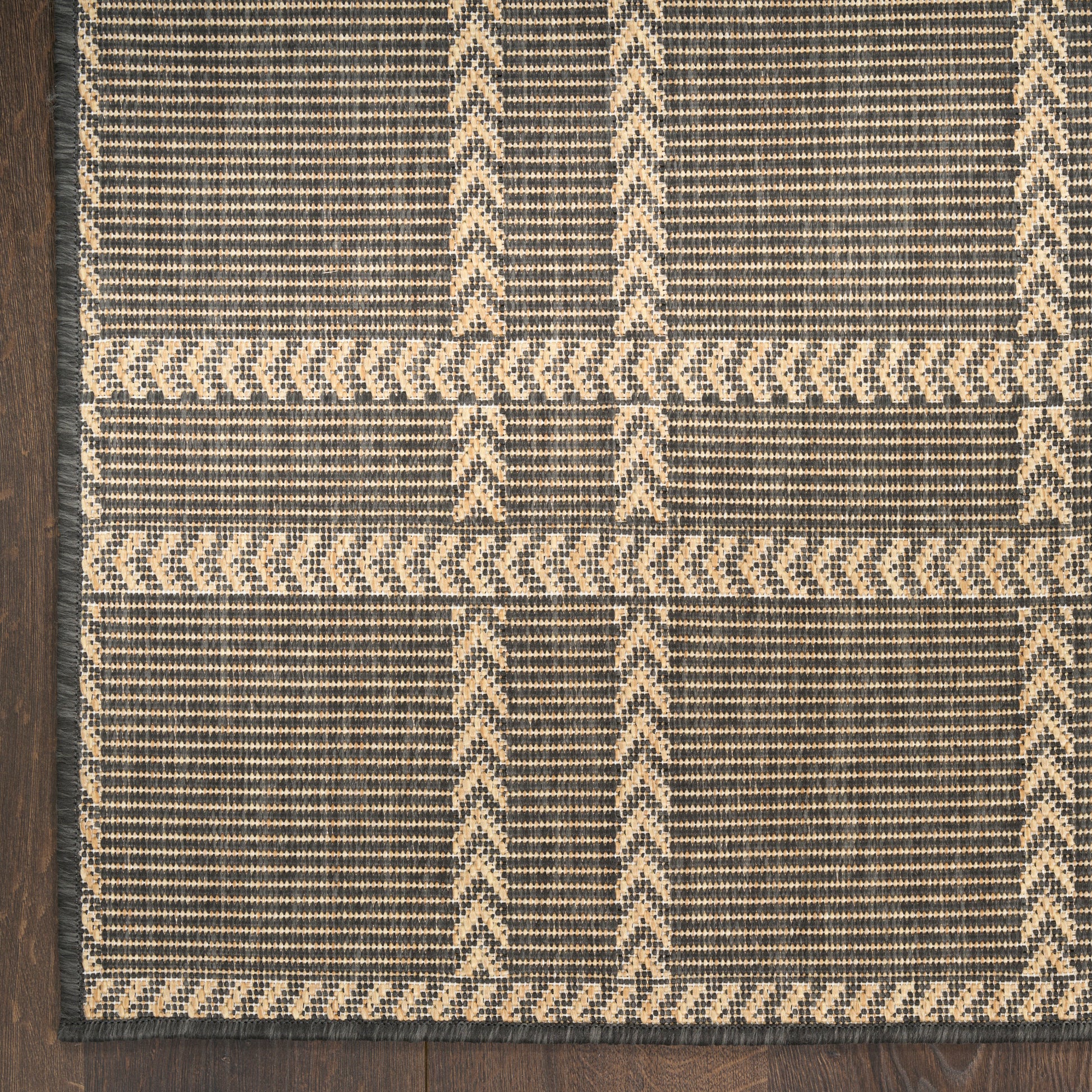 Rectangular handwoven flatweave rug, navy blue with natural beige chevron geometric pattern and border.