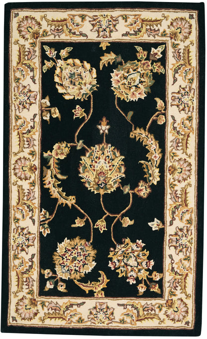 Rectangular Persian-style area rug with black field and ivory-gold floral border, ornate cream-and-gold vines.