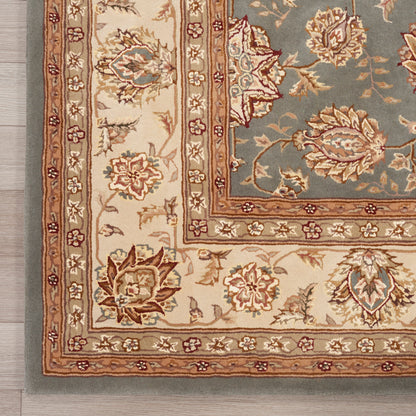 Traditional oriental rug with beige borders, blue-gray central field, and red-tan floral motifs; decorative rectangular rug.