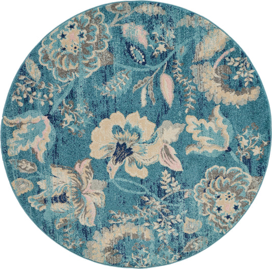 Round teal floral rug with beige and cream flowers and blush pink accents; ornate damask pattern.