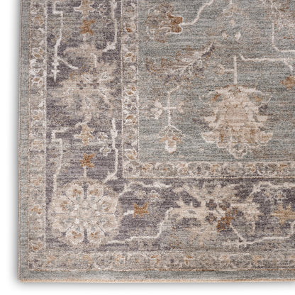 Distressed grey-blue oriental rug with beige floral motifs and a bordered pattern; woven texture.