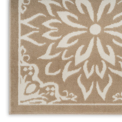 Beige woven area rug with white floral damask pattern and bordered edge.