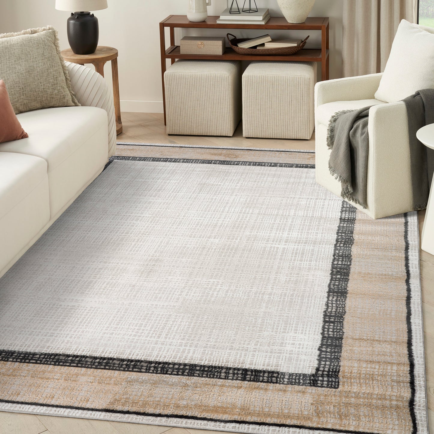 Rectangular woven cream rug with tan & dark gray borders for a modern neutral living room.