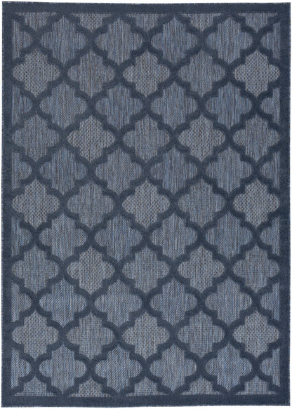 Blue woven area rug with a repeating dark navy trellis pattern and navy border.