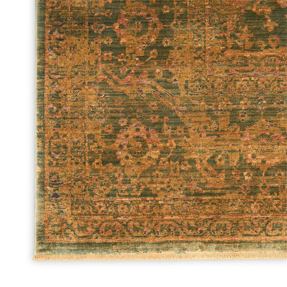 Distressed oriental rug close-up: olive-green field with orange-pink floral motifs and decorative border; fringe edge.