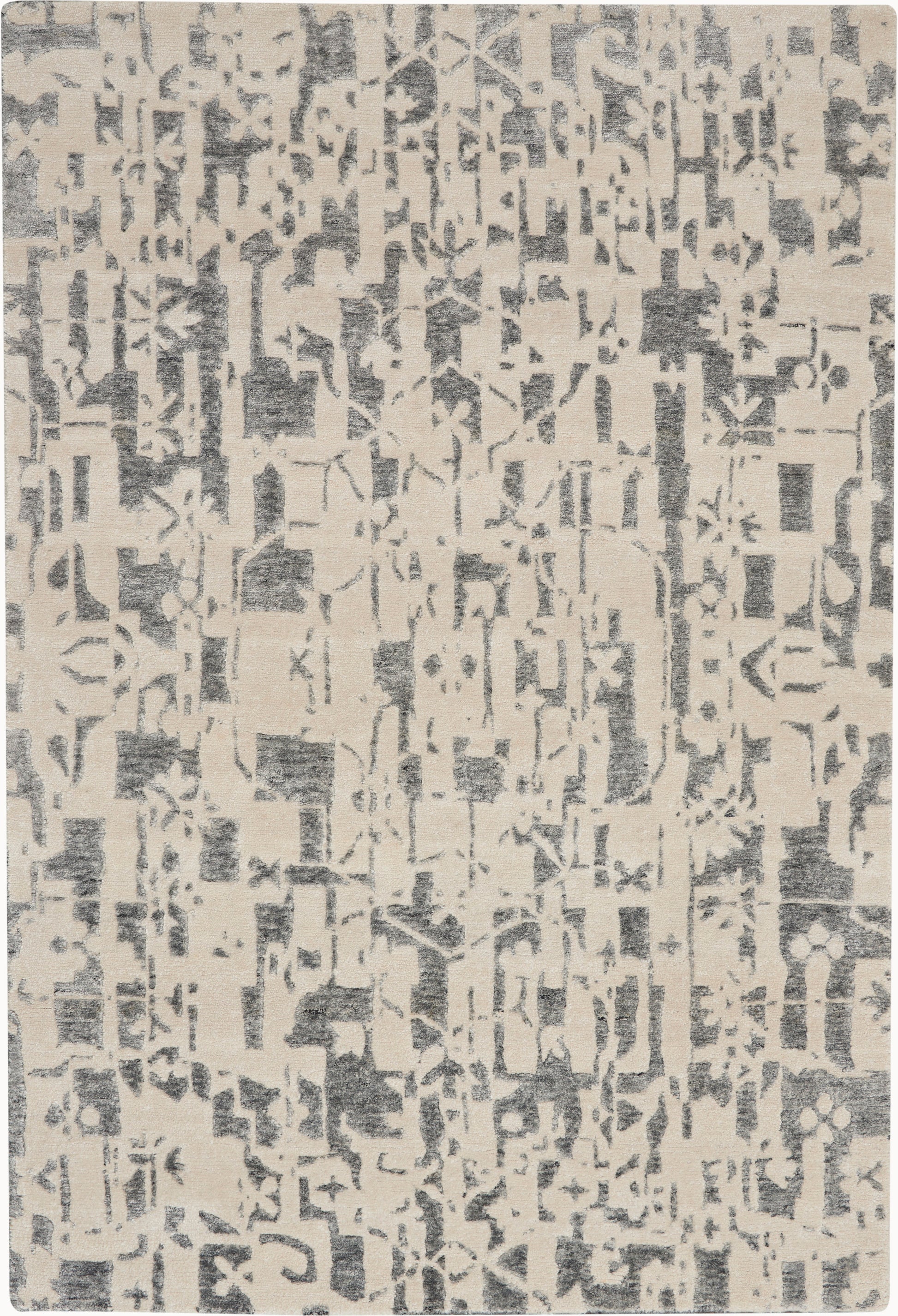 Beige area rug with an abstract charcoal gray distressed pattern; rectangular, soft woven texture.