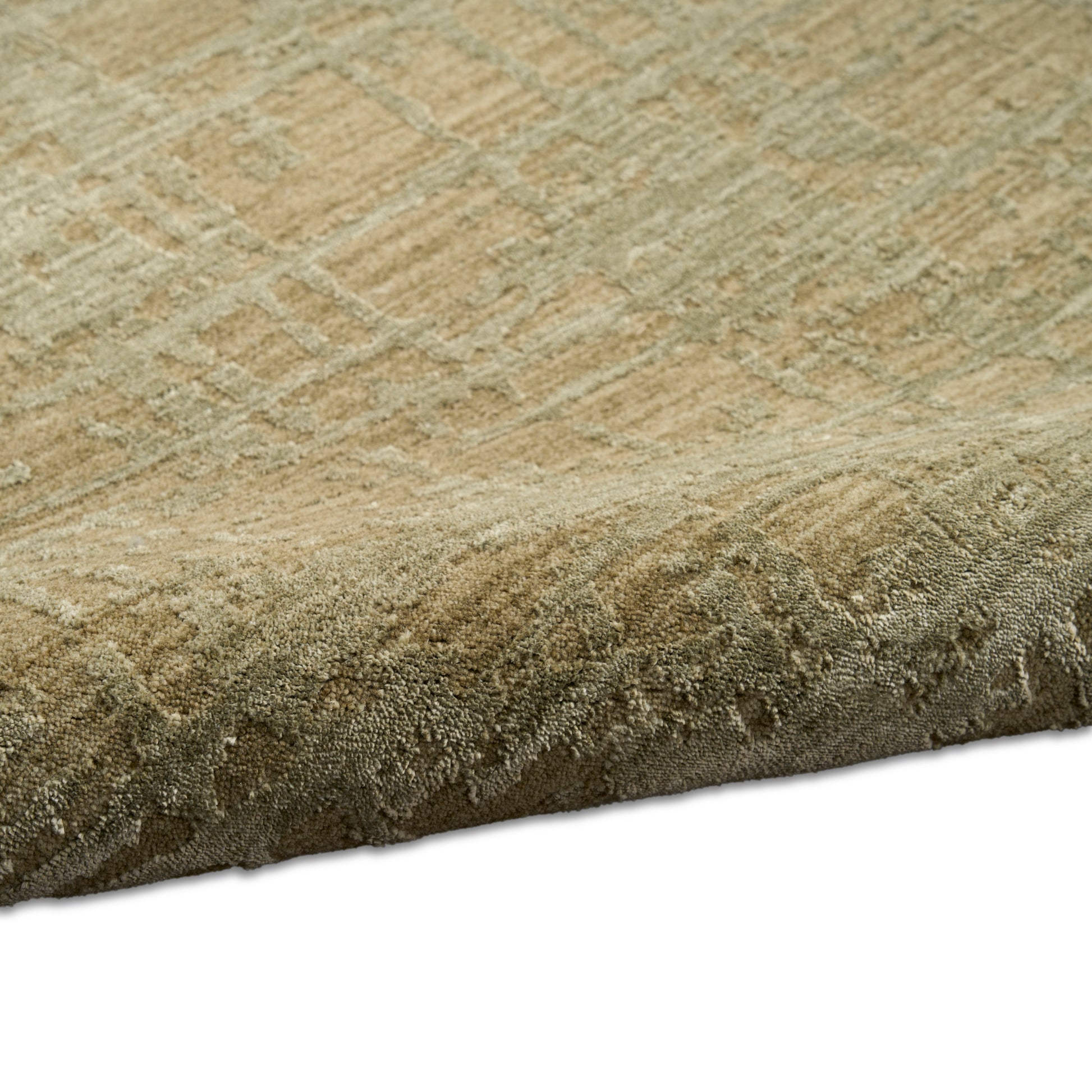 Beige-toned area rug with subtle geometric pattern & plush textured weave; rolled edge visible.
