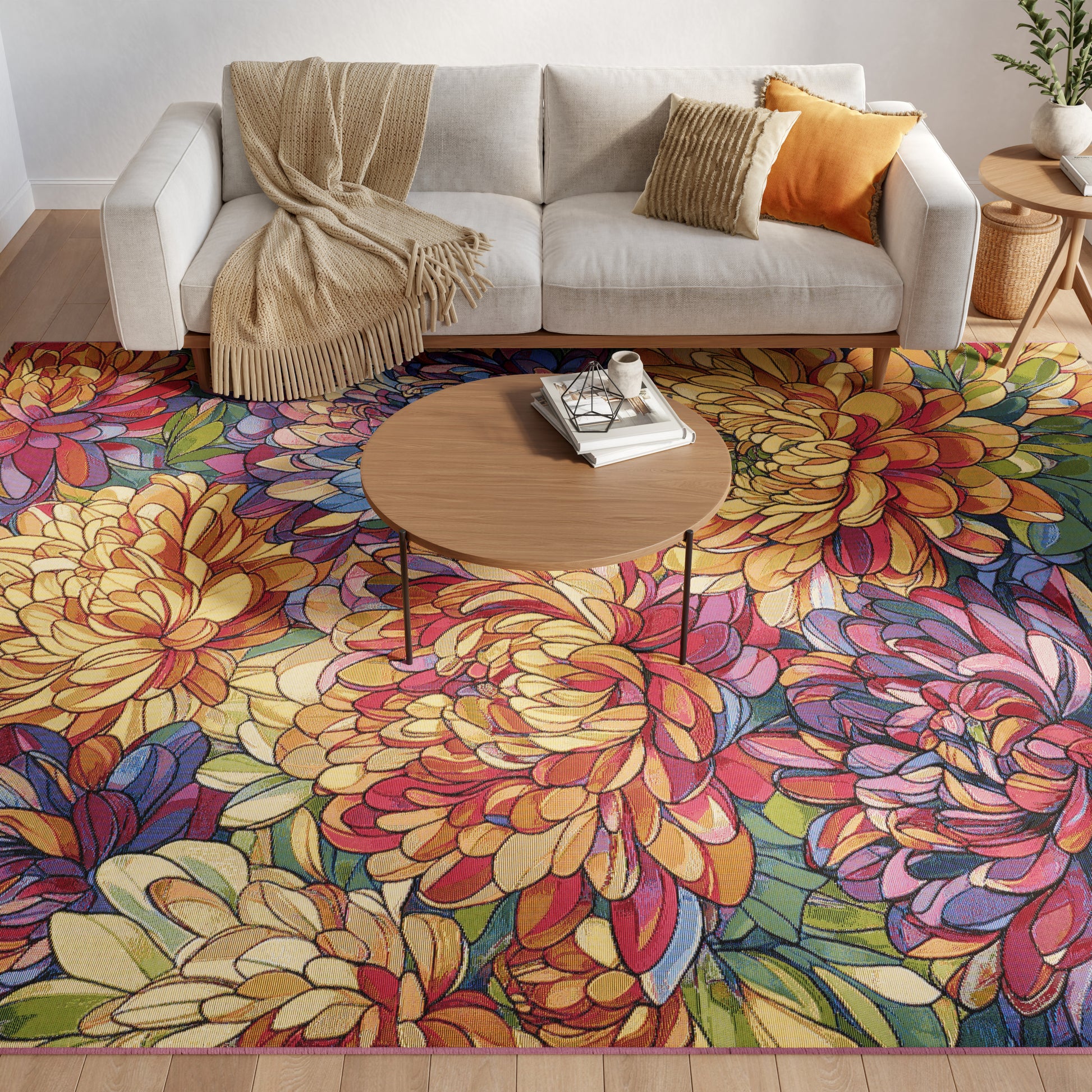 Colorful floral rug with large petal motifs in yellow, pink, blue and green under a round coffee table and beige sofa.