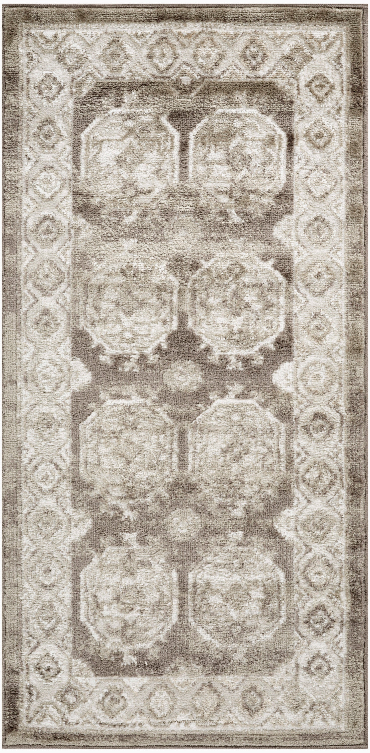 Beige oriental rug with repeating circular medallions in taupe and ivory, framed by a floral border.