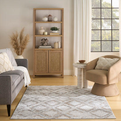 Geometric rug in a living room scene with grey sofa, beige curved armchair, round side table, light wood furniture and a grid window.