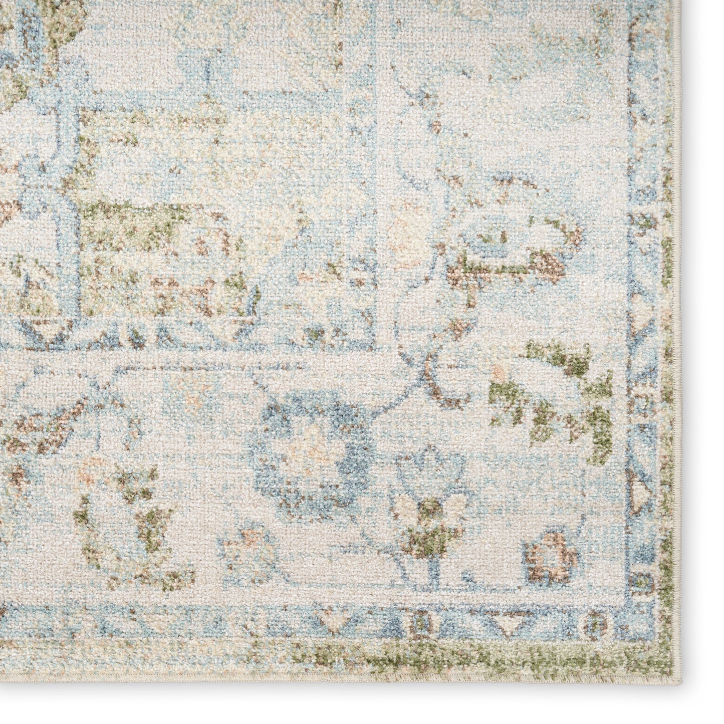 Pastel blue and cream floral area rug with subtle green accents and an ornate border.