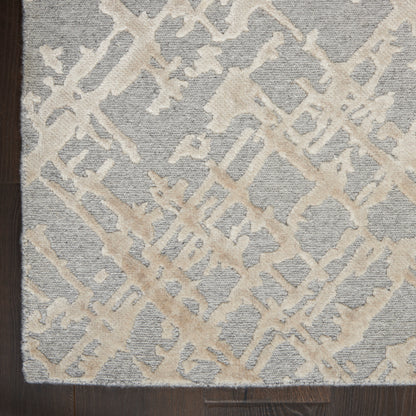 Rectangular area rug with cream-beige abstract lattice on gray-blue base; textured pile, modern living room decor.