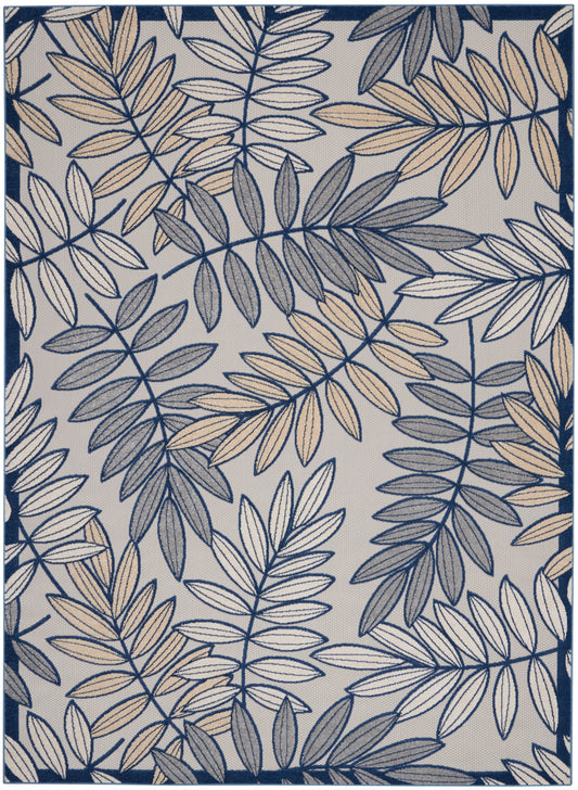Rectangular area rug with navy and beige fern-like leaf pattern on light gray background, navy border.