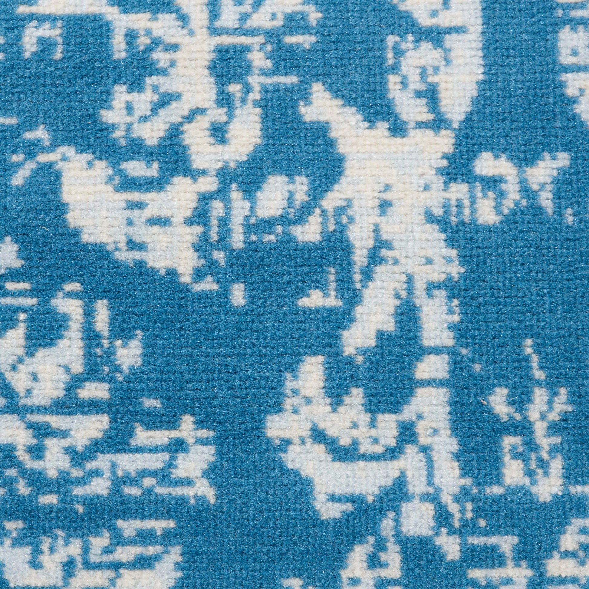 Blue & white woven textile with abstract damask floral pattern; versatile rug or upholstery fabric.