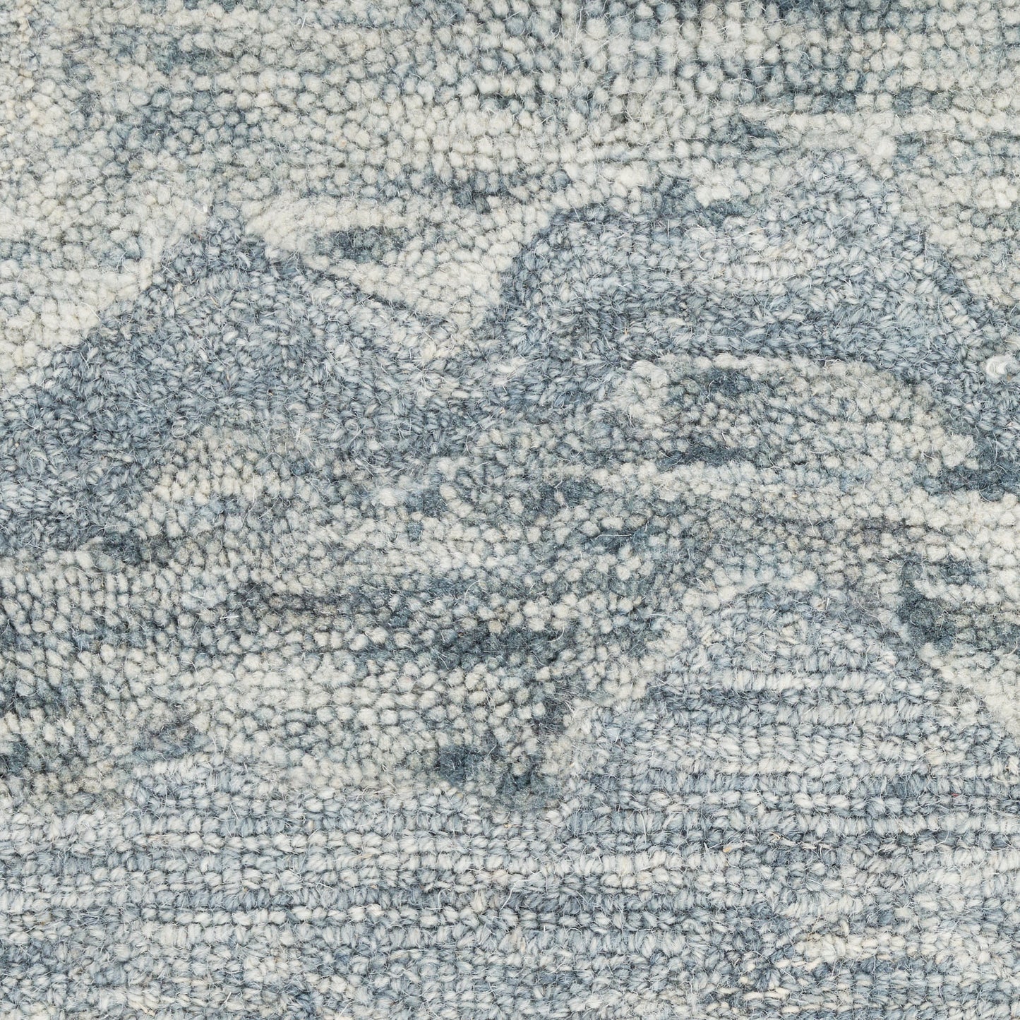 Blue-gray textured rug with abstract mountain pattern, loop-pile finish for a cozy, casual look.