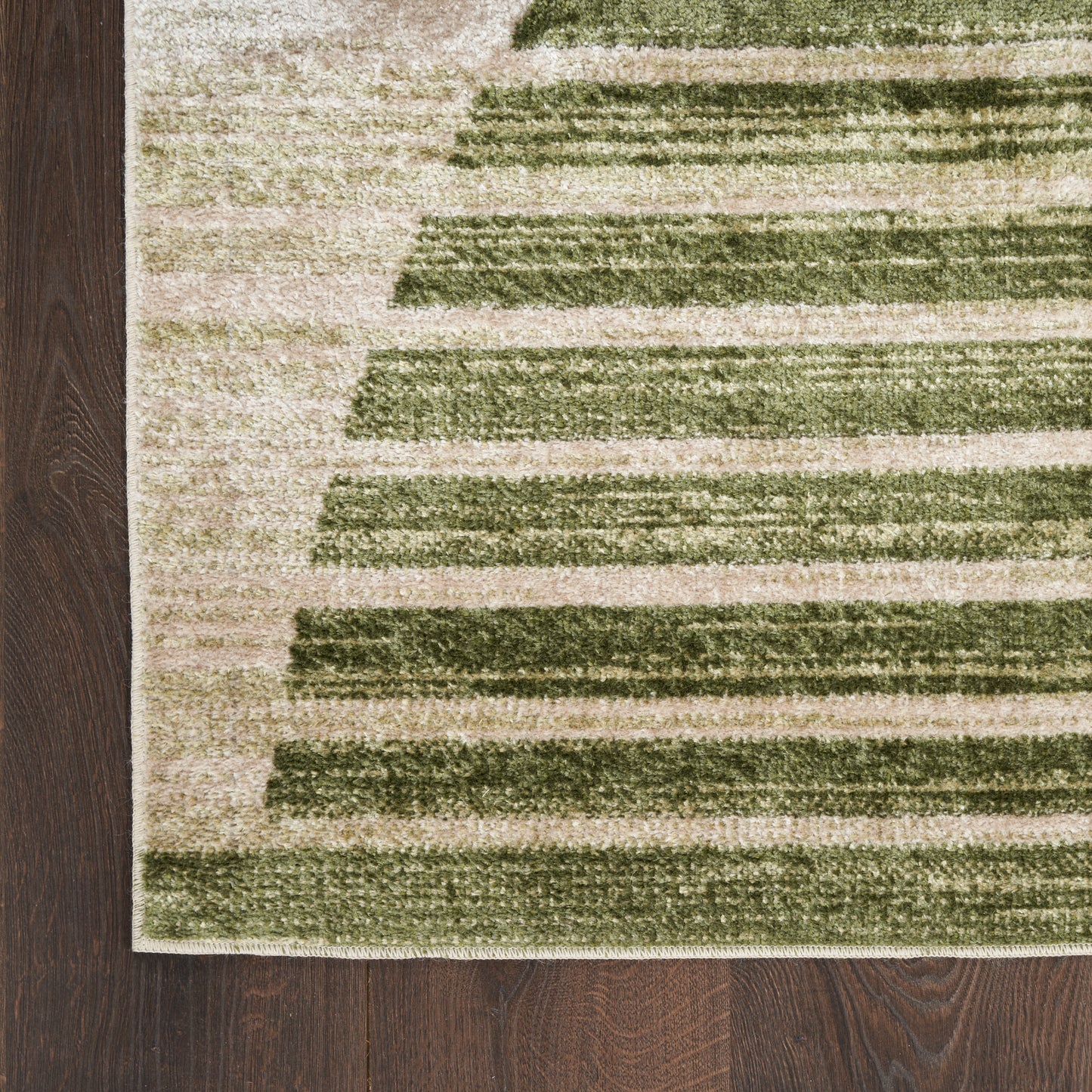 Rectangular beige rug with olive-green horizontal stripes, modern geometric low-pile, on dark wood floor.