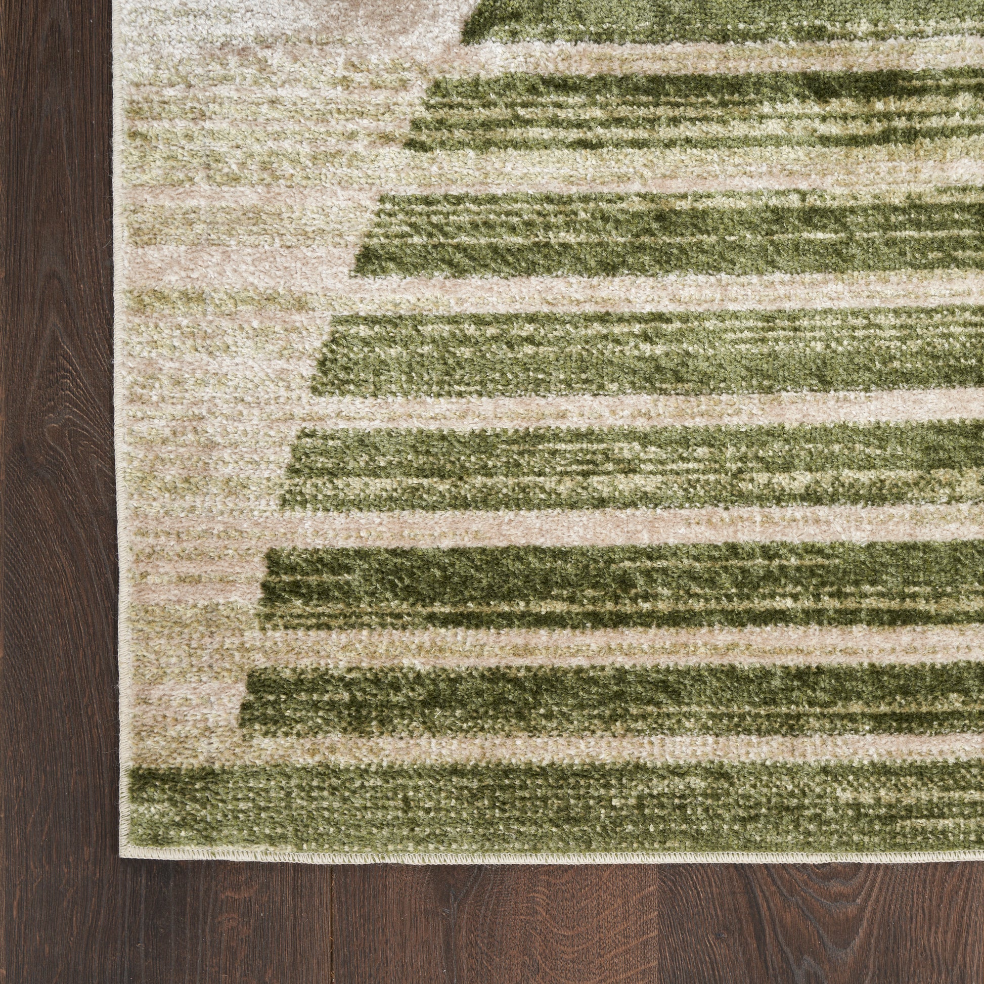 Rectangular beige rug with olive-green horizontal stripes, modern geometric low-pile, on dark wood floor.