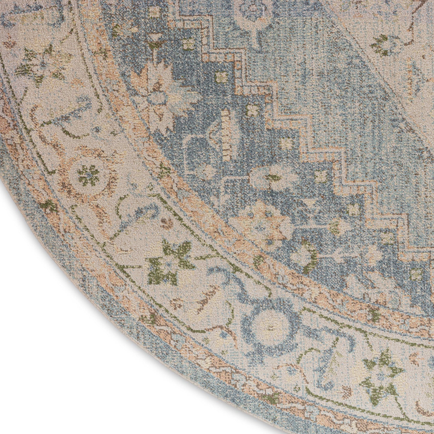 Round area rug featuring blue and cream floral border with peach accents and a vintage distressed look.