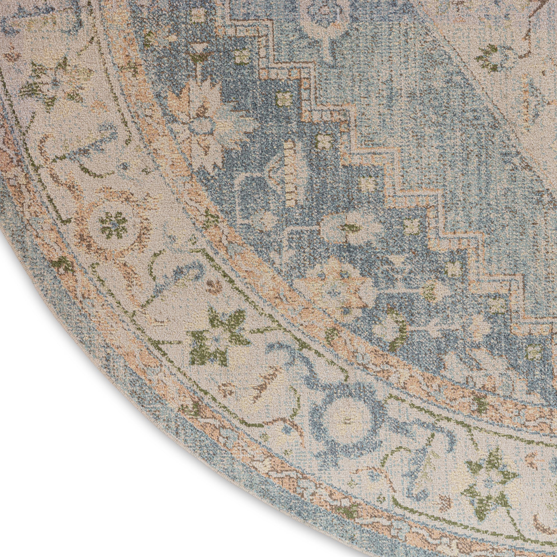 Round area rug featuring blue and cream floral border with peach accents and a vintage distressed look.