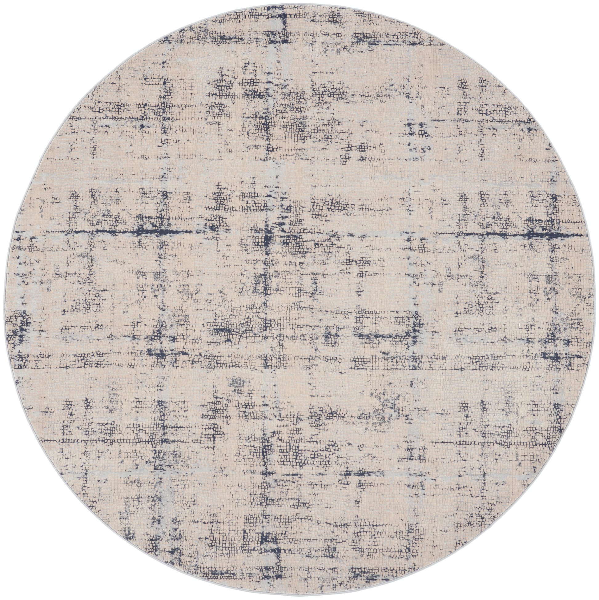 Round beige rug with navy distressed abstract pattern; textured surface, modern contemporary decor for living room.