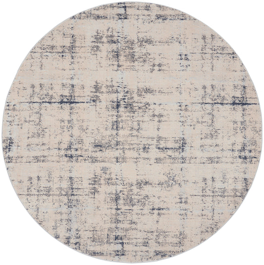 Round beige rug with navy distressed abstract pattern; textured surface, modern contemporary decor for living room.