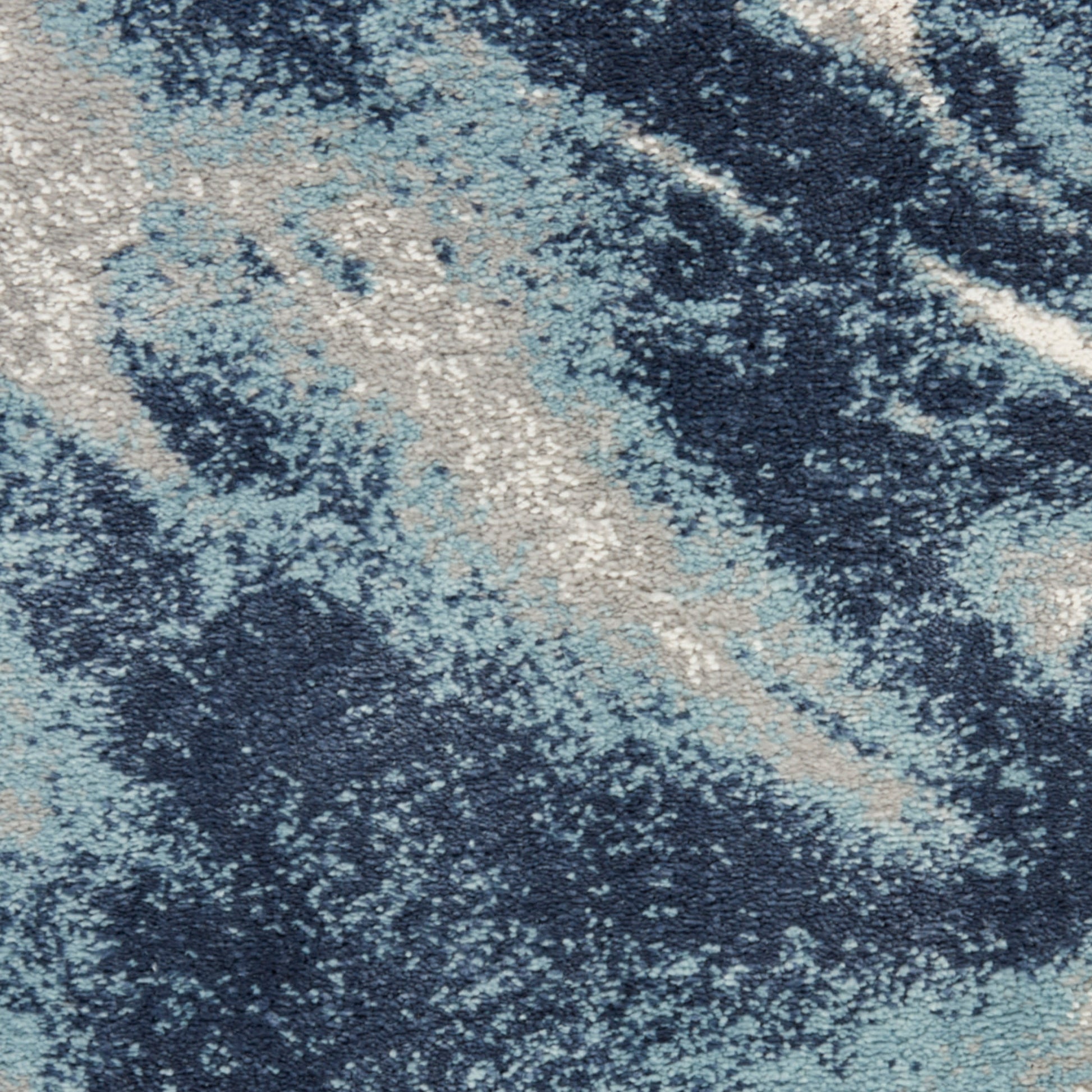 Abstract blue rug with navy, sky blue & beige marbled pattern; plush, soft area rug for living room.