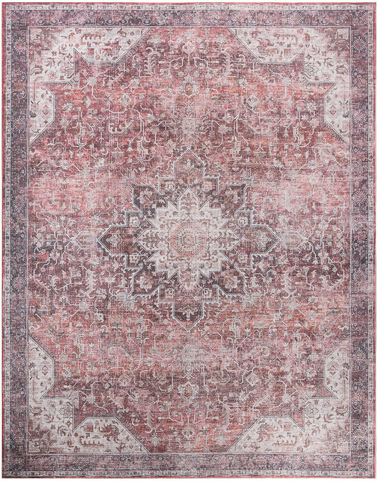 Distressed pink Oriental rug with ivory central medallion, ornate border and vintage floral pattern.