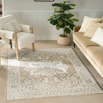 Beige ornate area rug with ivory floral medallion pattern, rectangular woven rug in a neutral living room.