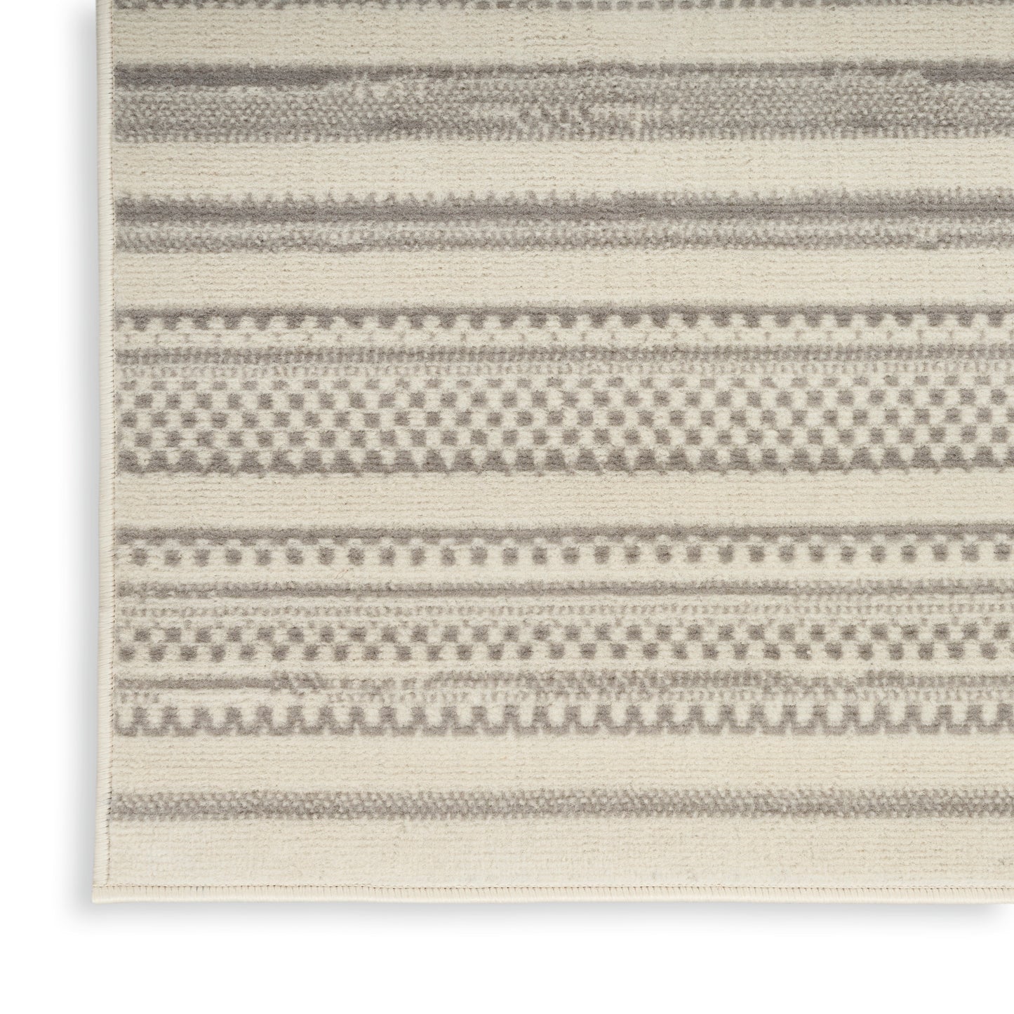 Neutral beige area rug with gray geometric stripes and dotted bands; woven texture for modern, minimalist decor.