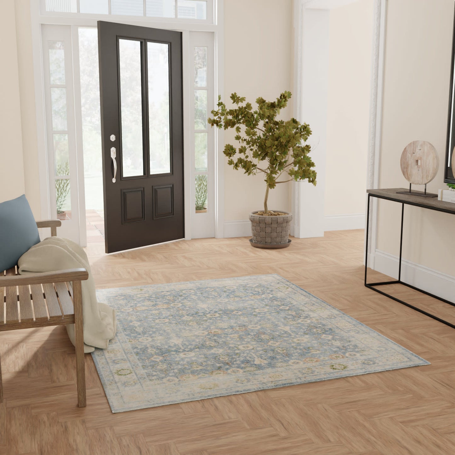 Bright entryway with light wood herringbone floor, blue-gray rug, black front door, potted tree, bench, and console table.