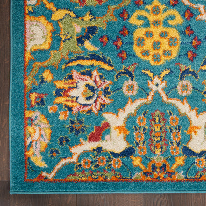 Teal oriental rug with intricate multicolor floral medallions, yellow and orange accents, bordered by teal on a wood floor.