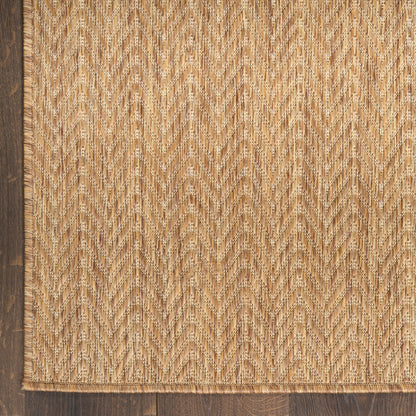 Natural jute rug with beige-tan chevron weave and dark wood border, rustic coastal style.