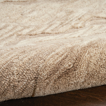 Beige shag rug with dense plush pile on dark wood floor; cozy, contemporary 5' x 7' rug.
