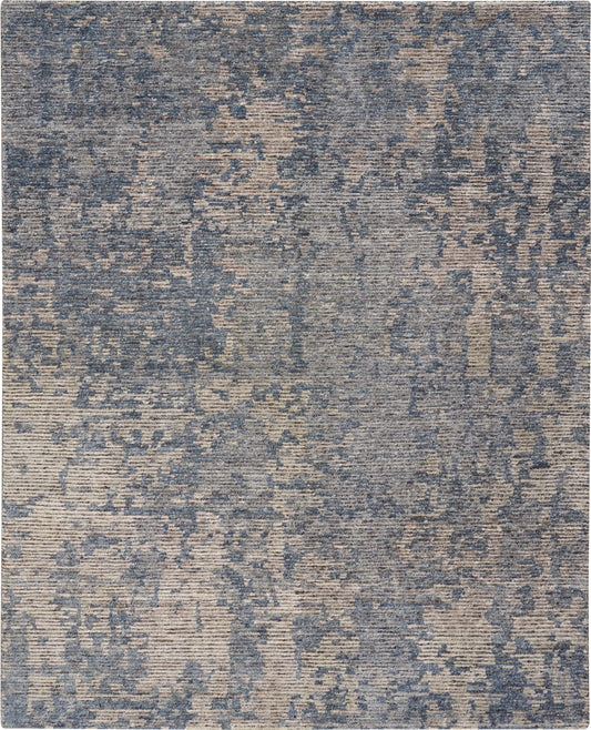 Rectangular blue and beige abstract rug with a distressed mottled pattern; versatile for modern living spaces.